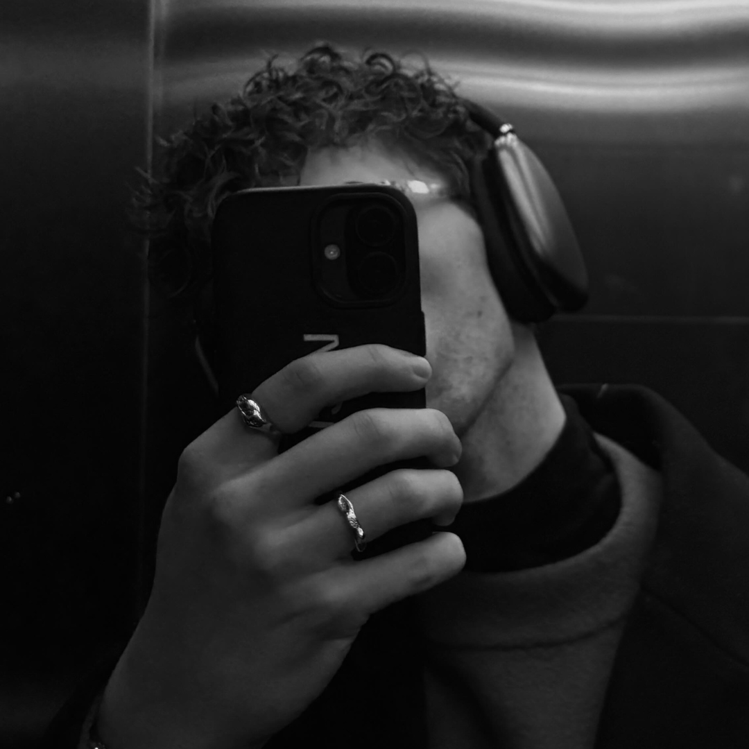 miror photo of a man wearing apple headphone and monateo jewelry