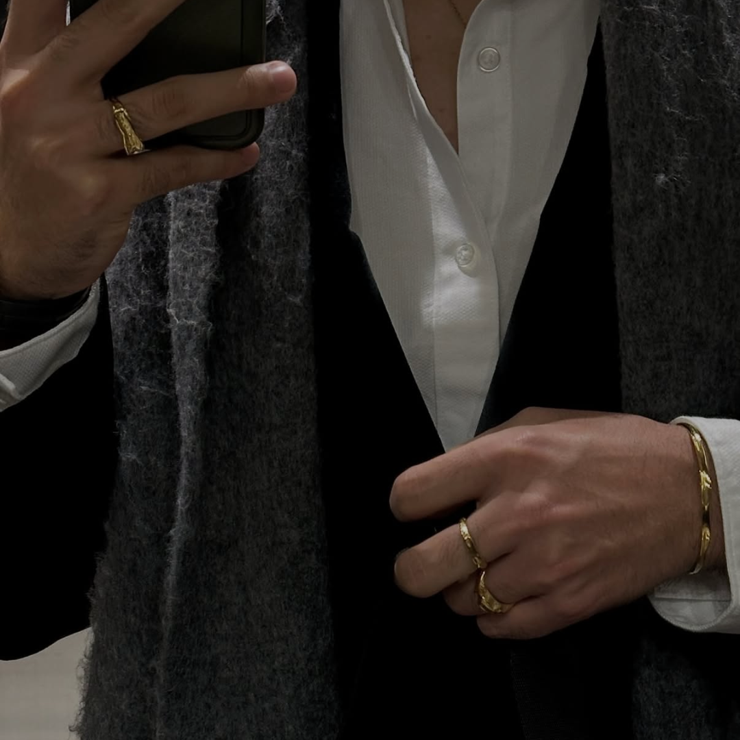 man mirror picture wearing monateo jewelry and coat