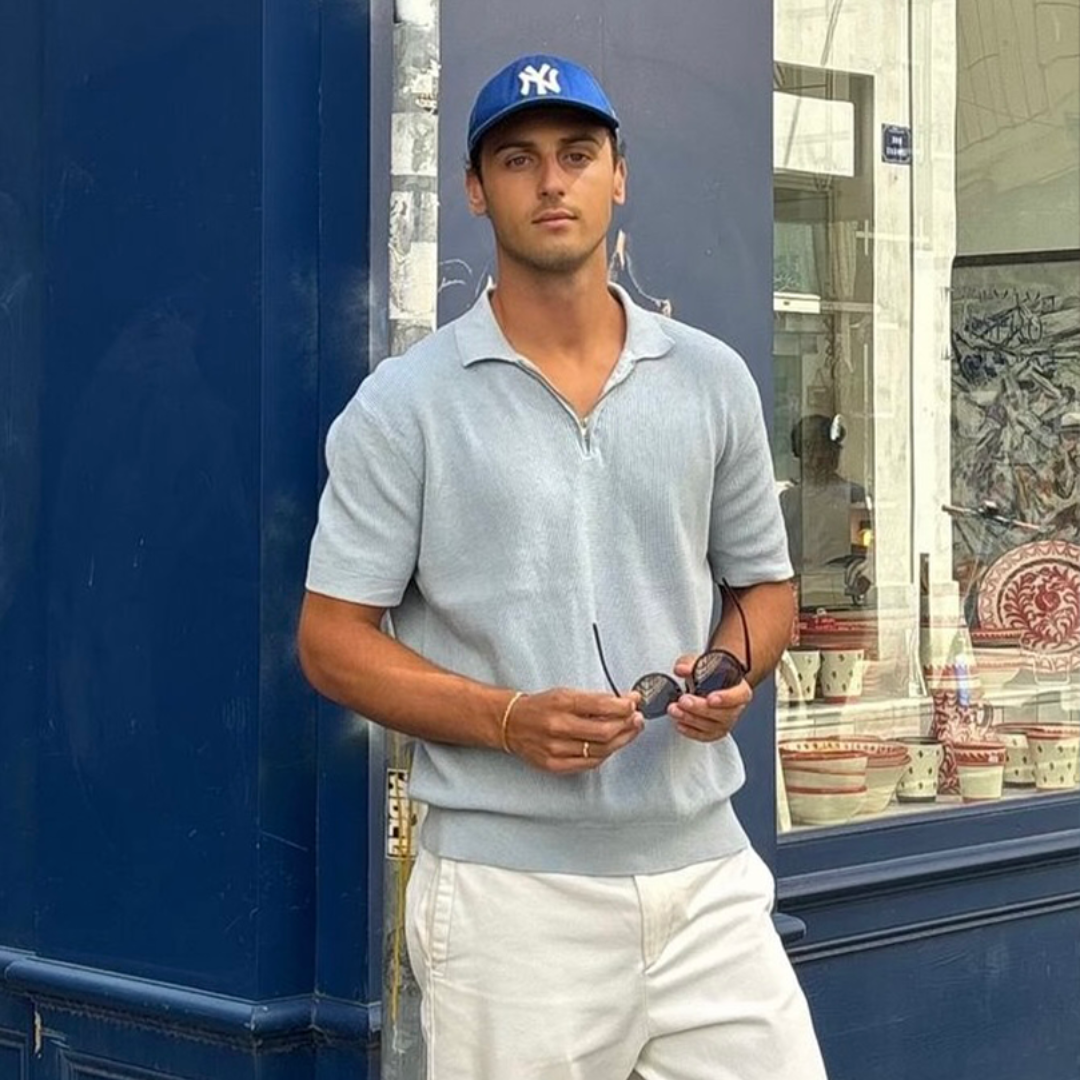 man in a blue polo wearing monateo jewelry