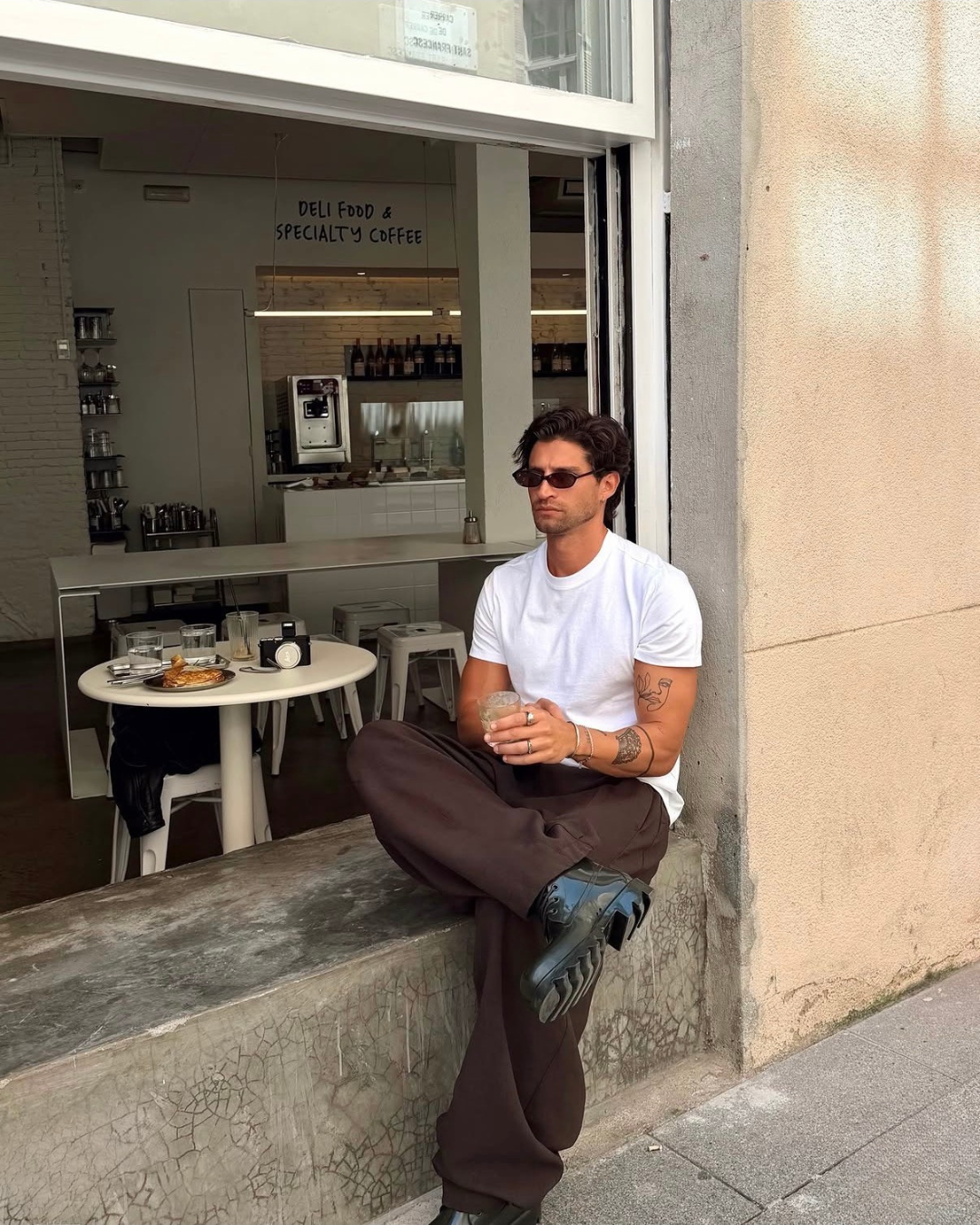 man in a coffee shop wearing monateo jewelry