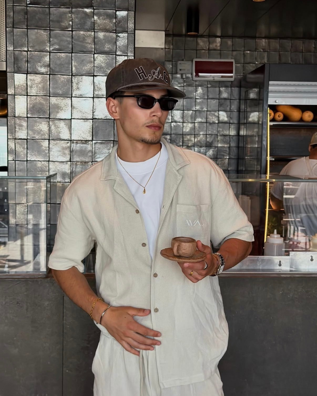 man in coffee shop wearing monateo jewelry