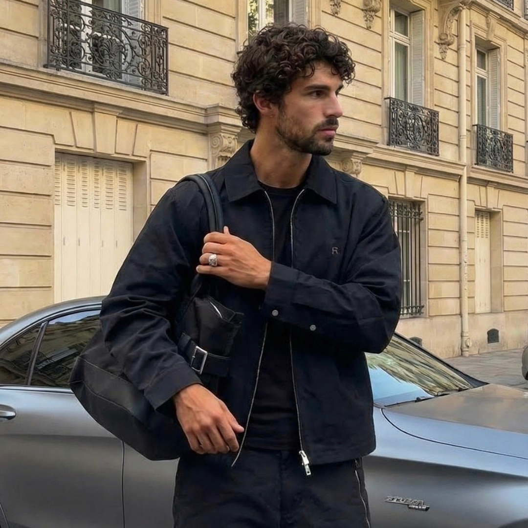 fashionable man wearing a hand bag and monateo jewelry