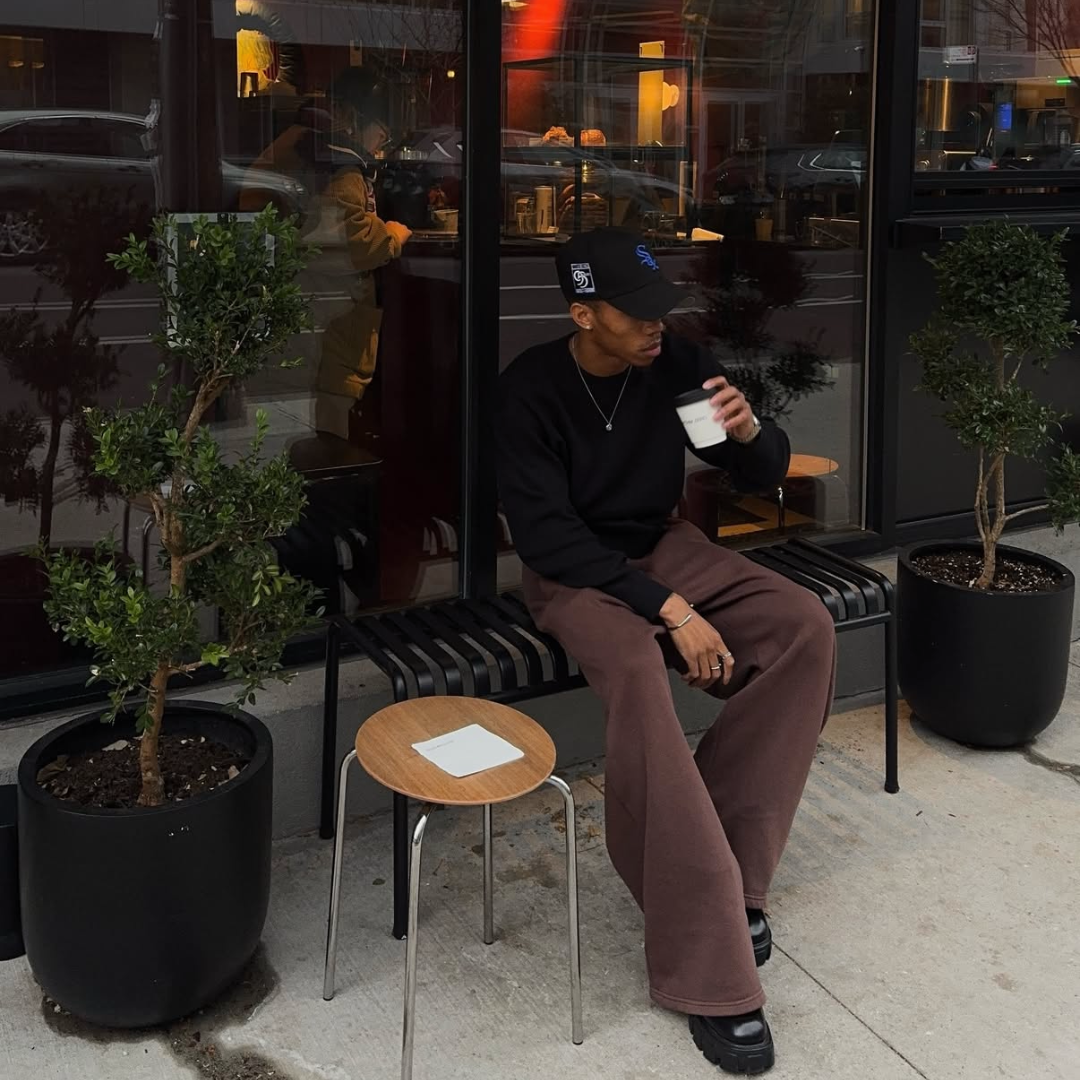 man drinking coffee in NYC with monateo jewelry